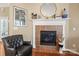 Living room fireplace featuring tile surround, white mantle, and decorative mirror at 9415 Rosalyn Glen Rd, Cornelius, NC 28031
