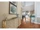 Inviting foyer with hardwood floors, elegant console table, and view into a bright living area at 9415 Rosalyn Glen Rd, Cornelius, NC 28031