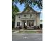 Charming two-story home featuring a cozy front porch and beautifully landscaped front yard, with blue sky in the background at 9415 Rosalyn Glen Rd, Cornelius, NC 28031