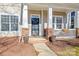 Inviting home entrance with a cozy porch, brick accents, and well-maintained landscaping at 9415 Rosalyn Glen Rd, Cornelius, NC 28031