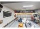 Finished garage with overhead storage, seating area, and TV at 9415 Rosalyn Glen Rd, Cornelius, NC 28031