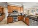 Well-equipped kitchen with stainless steel appliances, granite countertops, and wooden cabinetry at 9415 Rosalyn Glen Rd, Cornelius, NC 28031