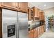 Modern kitchen featuring stainless steel refrigerator and wooden cabinets with granite countertops at 9415 Rosalyn Glen Rd, Cornelius, NC 28031