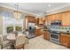Bright kitchen with stainless appliances, wooden cabinets, and a cozy breakfast nook at 9415 Rosalyn Glen Rd, Cornelius, NC 28031