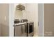 Modern laundry room with updated machines, storage and space at 9415 Rosalyn Glen Rd, Cornelius, NC 28031