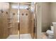 Close up of the tiled shower featuring tiled accent designs and built-in shelving at 9415 Rosalyn Glen Rd, Cornelius, NC 28031