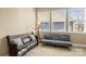 Sunlit sitting room with bench and gray sofa near bright windows at 9415 Rosalyn Glen Rd, Cornelius, NC 28031