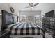 Main bedroom with a king-size bed, black dresser, and ceiling fan at 10225 Black Locust Ln, Charlotte, NC 28215