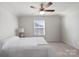 Bright bedroom with carpeted floor, ceiling fan, and window with blinds at 10225 Black Locust Ln, Charlotte, NC 28215