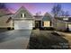 Gray craftsman style home with a two-car garage and American flag at 10225 Black Locust Ln, Charlotte, NC 28215