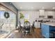 Bright kitchen with white cabinets, an island, and sliding glass doors leading to a patio at 10225 Black Locust Ln, Charlotte, NC 28215