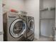 Convenient laundry room with washer, dryer, and shelving at 10225 Black Locust Ln, Charlotte, NC 28215