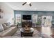 Living room featuring a sectional sofa, coffee table, and hardwood floors at 10225 Black Locust Ln, Charlotte, NC 28215