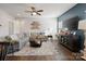 Living room with sectional sofa, coffee table, hardwood floors, and a ceiling fan at 10225 Black Locust Ln, Charlotte, NC 28215