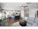 Open concept living room and kitchen with hardwood floors, gray couch, and ceiling fan at 10225 Black Locust Ln, Charlotte, NC 28215