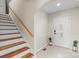 Bright entryway with staircase, tile flooring, and potted plants at 104 Brookview Dr, Shelby, NC 28152