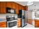 Stainless steel appliances and wood cabinets in kitchen at 104 Brookview Dr, Shelby, NC 28152