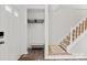 Bright entryway with stairs, coat closet, and wood floors at 1115 Scaleybark Rd # D, Charlotte, NC 28209