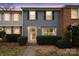 Inviting brick and gray siding townhouse with well-manicured landscaping at 1115 Scaleybark Rd # D, Charlotte, NC 28209