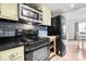 Black appliances and butcher block kitchen island at 1115 Scaleybark Rd # D, Charlotte, NC 28209