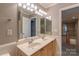 Bathroom featuring a double sink with wood cabinets and a large mirror at 117 Biscayne Ct, Mooresville, NC 28117