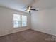 Bedroom with neutral carpet, ceiling fan, and a window with blinds at 117 Biscayne Ct, Mooresville, NC 28117