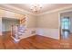 Elegant dining room with wainscoting detail, hardwood floors and chandelier, showcasing refined style at 117 Biscayne Ct, Mooresville, NC 28117