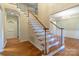 Inviting foyer with gleaming hardwood floors and elegant staircase leading to the upper level at 117 Biscayne Ct, Mooresville, NC 28117