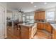 Bright kitchen with island, wood cabinets, and view into adjacent living area at 117 Biscayne Ct, Mooresville, NC 28117