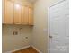 Functional laundry area with cabinets and a utility sink at 117 Biscayne Ct, Mooresville, NC 28117