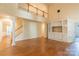 Spacious living area with hardwood floors, built-in cabinets, and a view of the upper-level balcony at 117 Biscayne Ct, Mooresville, NC 28117