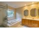 Main bathroom with a large soaking tub and double vanity at 117 Biscayne Ct, Mooresville, NC 28117