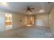 Main bedroom featuring a tray ceiling and multiple windows for natural light at 117 Biscayne Ct, Mooresville, NC 28117