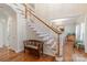 Elegant wooden staircase with ornate railing and bench at 117 Biscayne Ct, Mooresville, NC 28117