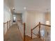 Upstairs hallway with hardwood floors and access to bedrooms at 117 Biscayne Ct, Mooresville, NC 28117