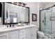 Beautiful bathroom featuring double sinks, a marble countertop and a large glass shower at 11735 Ridgeway Park Dr, Charlotte, NC 28277