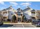 Inviting exterior view of this tan condo with manicured landscaping, parking and a welcoming entrance at 11735 Ridgeway Park Dr, Charlotte, NC 28277