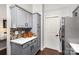 Gray kitchen with stainless steel fridge, mosaic backsplash, and white countertops at 11735 Ridgeway Park Dr, Charlotte, NC 28277