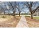 Scenic park featuring walking paths, picnic tables, trees, and barbecue grills, ideal for outdoor gatherings at 11735 Ridgeway Park Dr, Charlotte, NC 28277