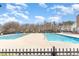 A beautiful community pool on a sunny day with lounge seating and a clear blue swimming area at 11735 Ridgeway Park Dr, Charlotte, NC 28277