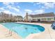 Community pool on a sunny day with lounge seating and a clear blue swimming area and nearby pool house at 11735 Ridgeway Park Dr, Charlotte, NC 28277