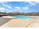 A beautiful community pool on a sunny day with lounge seating and a clear blue swimming area at 11735 Ridgeway Park Dr, Charlotte, NC 28277