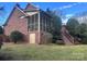 Brick home with a screened porch and wooden deck at 1180 Asheford Green Ave # 46, Concord, NC 28027