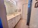 Clean bathroom with vanity, sink, and linen closet at 1180 Asheford Green Ave # 46, Concord, NC 28027