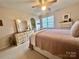 Bright bedroom with double bed, dresser, and window at 1180 Asheford Green Ave # 46, Concord, NC 28027