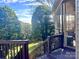 Deck steps leading to a screened porch and grassy backyard at 1180 Asheford Green Ave # 46, Concord, NC 28027