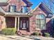 Brick facade with a charming red door and arched window at 1180 Asheford Green Ave # 46, Concord, NC 28027