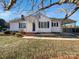 Front view of a charming white house with a covered carport at 1215 Neal Hawkins Rd, Gastonia, NC 28056