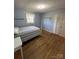 Bright bedroom with hardwood floors, a full-size bed, and a window at 1217 Burke Rd, Shelby, NC 28152