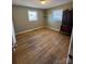 Bedroom with hardwood floors and built-in shelving at 1217 Burke Rd, Shelby, NC 28152